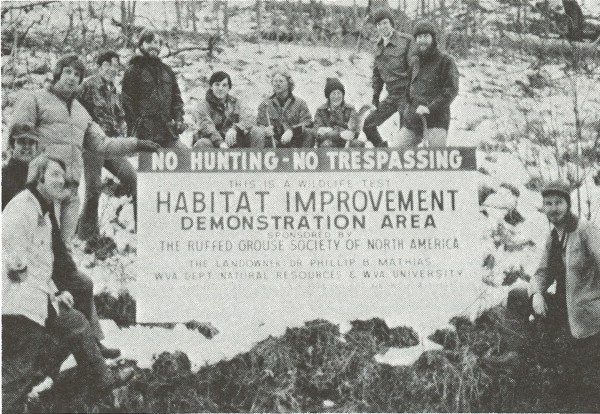 1974-05 WVU grad wildlife class at habitat improvement demo area sign